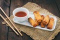 Mini spring rolls with sweet spicy dip and chopsticks