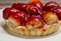 Mini strawberry cheese cake tart close up on white plate - fruity cheesecake background