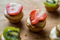 Mini Tarts, Tartolet or Tartlets with Strawberry, Cream and fresh fruits. Royalty Free Stock Photo