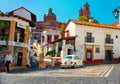 Mini taxi against the Cathedral of Taxco, Mexico.