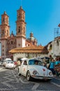 Mini taxi against the Cathedral of Taxco, Mexico Royalty Free Stock Photo