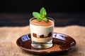 mini tiramisu served in a dessert glass with a mint leaf