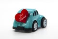 Mini toy car carrying red heart shape with text Just Married. Newly wed couple concept. Royalty Free Stock Photo