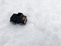 Mini toy maket black CUV car in the snow winter background cold weather problems