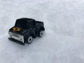 Mini toy maket black CUV car in the snow winter background cold weather problems