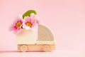 Mini toy wooden cargo truck model with beautiful fresh spring flowers