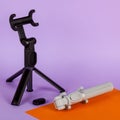 Mini tripod selfie stick for moblie phone on purple background