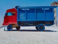 a mini truck made of red and blue wood.