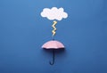 Mini umbrella and paper lighting cloud on blue background, flat lay Royalty Free Stock Photo