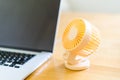 Mini usb fan near laptop. Summer office day. Mini portable cooler Royalty Free Stock Photo