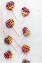 Mini Valentine decorated waffle pops, against a light background.