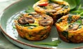 Mini vegetable frittatas with spinach and mushrooms on a pastel green plate Royalty Free Stock Photo