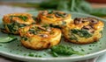 Mini vegetable frittatas with spinach and mushrooms on a pastel green plate Royalty Free Stock Photo