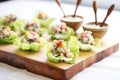 mini waldorf salads in bite-sized lettuce cups on a wood tray Royalty Free Stock Photo