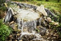 Mini waterfall in the city park, natural scene Royalty Free Stock Photo