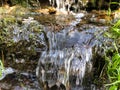 Mini waterfall on the rocks on a sunny day Royalty Free Stock Photo