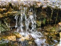 Mini waterfall on the rocks on a sunny day Royalty Free Stock Photo