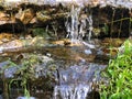 Mini waterfall on the rocks on a sunny day Royalty Free Stock Photo