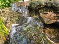 Mini waterfall on the rocks on a sunny day Royalty Free Stock Photo