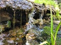 Mini waterfall on the rocks on a sunny day Royalty Free Stock Photo