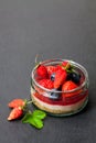 Mini wild forest berries cheesecake in a glass pot on black sto Royalty Free Stock Photo