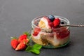 Mini wild forest berries cheesecake in a glass pot on black sto Royalty Free Stock Photo