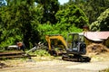 A mini yellow construction loader machine with workers at the railway site Royalty Free Stock Photo