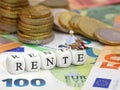 miniatur old man sitting on letter cubes RENTE, the german word for pension, with euro money bankotes and coins Royalty Free Stock Photo