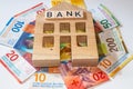 Miniature bank of switzerland and a bundle of swiss francs, business concept, banking business, financial stabilization, lending,