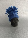 Miniature Black skull wearing a winter hat