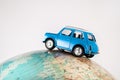 NIS, SERBIA - JANUARY 8 2018 Miniature figure toy car Mini Morris on geographical globe of earth on white background in studio Royalty Free Stock Photo