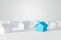 Miniature blue house in among white houses for real estate property industr Royalty Free Stock Photo