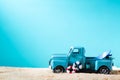 Miniature blue truck with surfboard and buoy