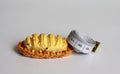 Miniature bread and white tape measure. Royalty Free Stock Photo