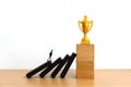 Miniature business concept - businessman walking on collapse stairway to reach golden trophy Royalty Free Stock Photo