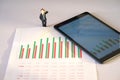 miniature business people and business financial eps chart data on white paper