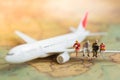 Miniature business people : businesses team waiting for airplane with copy space for travel around the world, business trip travel