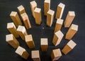 Miniature businessman stand in a circle of wooden blocks. Black background. Crisis and failure in Business, Insurance and Risk Man
