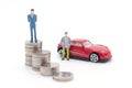 Miniature businessman standing on coins and the car behind. saving and loan concept. Royalty Free Stock Photo