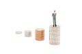 Miniature businessman standing on stack of new Thai Baht coins. Royalty Free Stock Photo