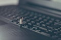 Miniature businessman waving on top of the laptop. Business concept Royalty Free Stock Photo