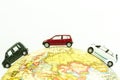 Miniature car around the globe close up. Image concept