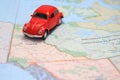 Miniature car driving on a map of the Yukon canada