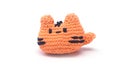 Miniature cat keychain in orange colors crocheted on a white background