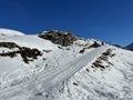 A miniature cemetery covered with fresh snow next to Arosa\'s mountain chapel (Das Bergkirchli Arosa)