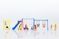 Miniature children: Group childrens are playing together on playground. Image use for Children`s Day. Royalty Free Stock Photo