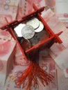 Miniature Chinese pavilion in bright red and filled with Chinese coins