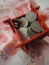 Miniature Chinese pavilion in bright red and filled with Chinese coins