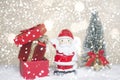 Miniature Christmas Santa cros and Tree on snow over blurred bokeh background,Decoration Image for Christmas Holiday and Happy New Royalty Free Stock Photo