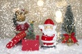 Miniature Christmas Santa cros and Tree on snow over blurred bokeh background,Decoration Image for Christmas Holiday and Happy New Royalty Free Stock Photo